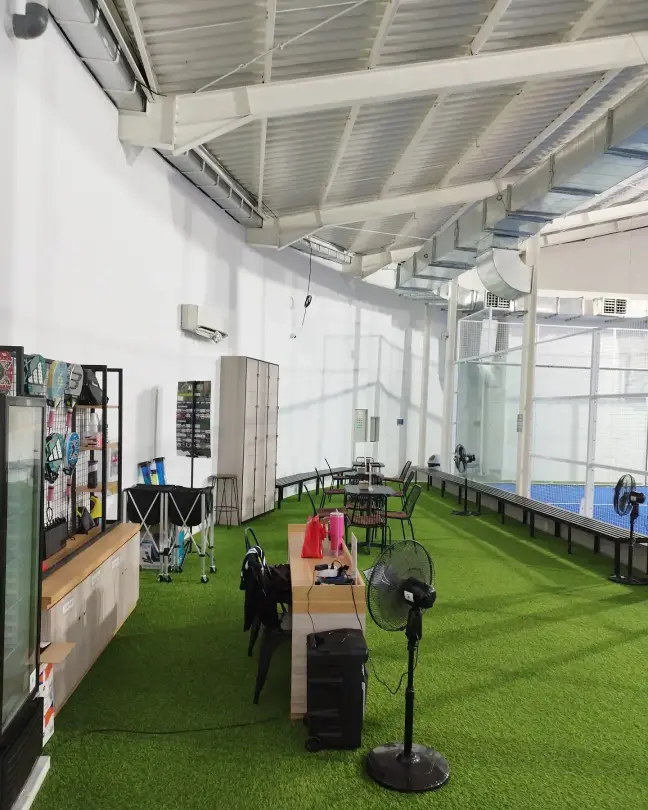 Turf deck with tables beside the courts