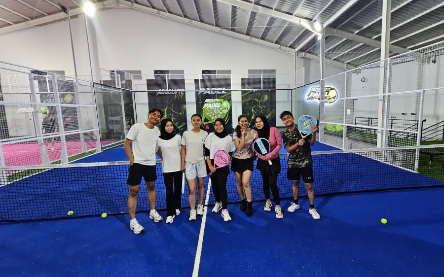 A group of players posing on the Blue Court
