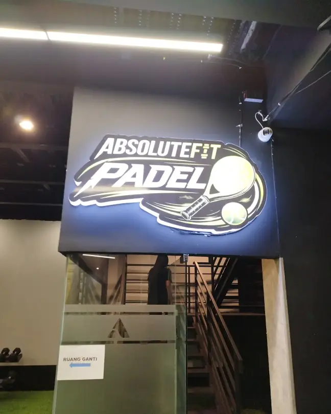 AbsoluteFit Padel sign above the stairs